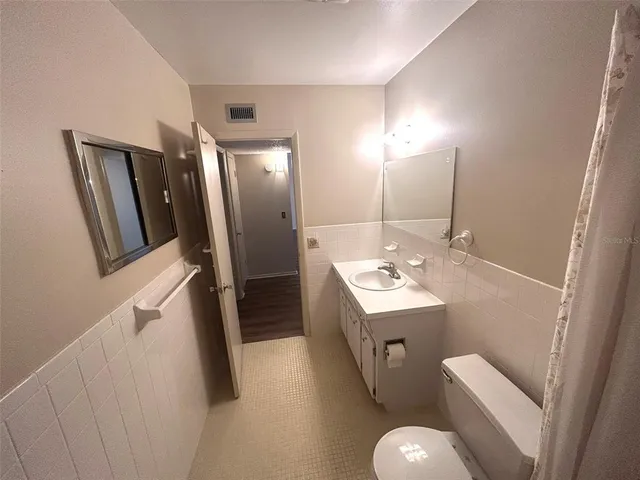 a bathroom with a sink toilet and mirror