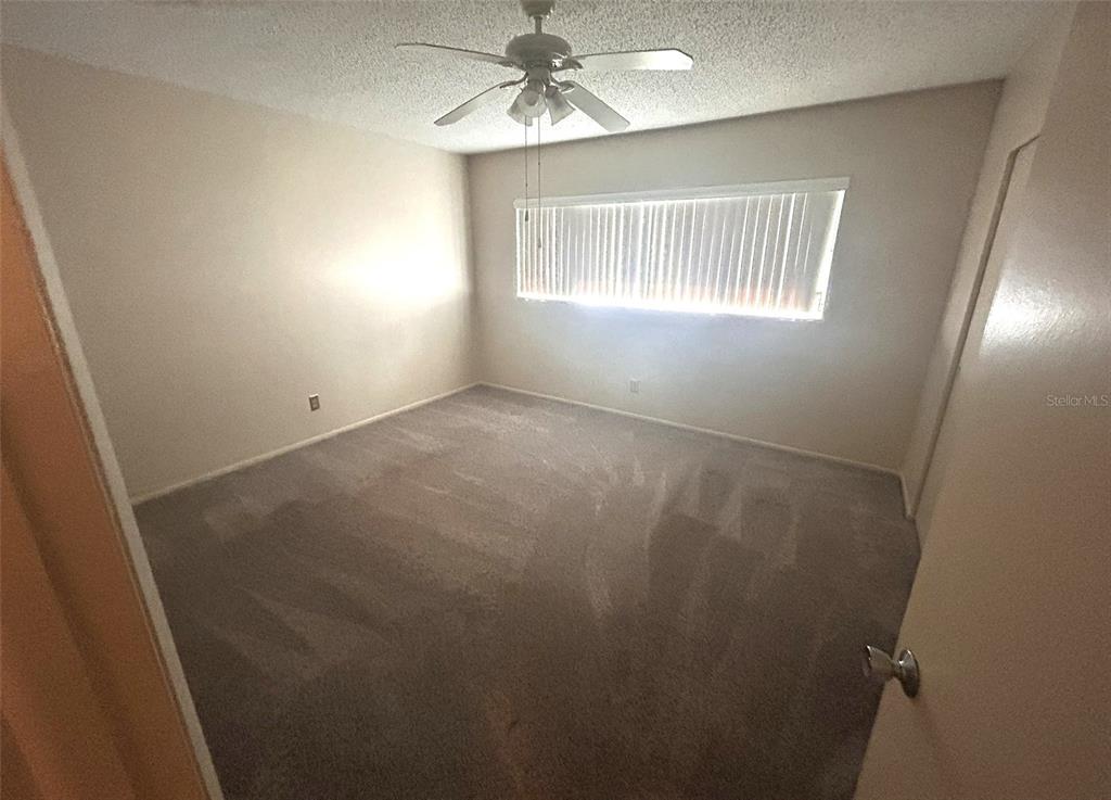 2402 Ecuadorian Way, Unit 18 Clearwater, FL 33763 - Photo 26 of 55 an empty room with windows and fan
