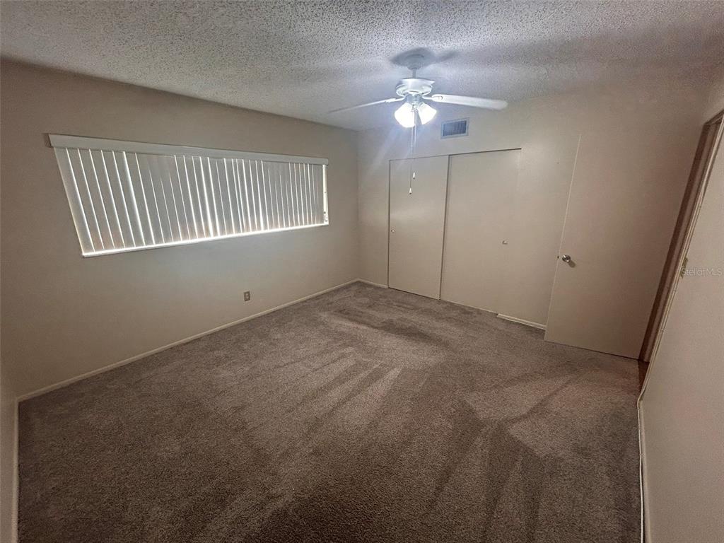 2402 Ecuadorian Way, Unit 18 Clearwater, FL 33763 - Photo 30 of 55 a view of an empty room with a chandelier fan