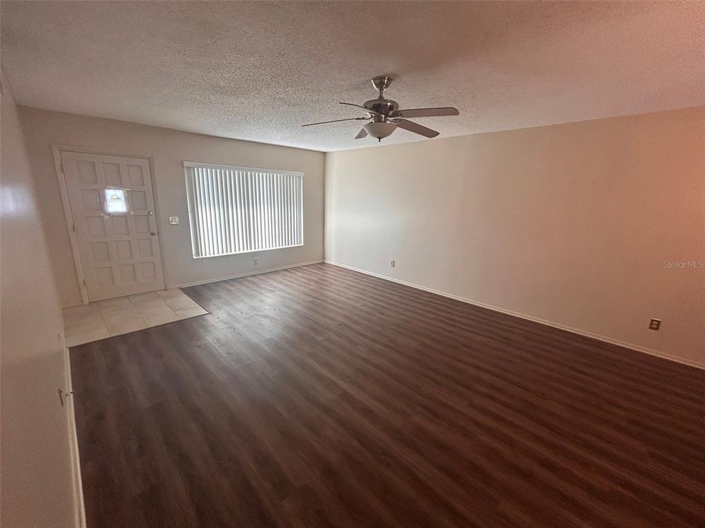 2402 Ecuadorian Way, Unit 18 Clearwater, FL 33763 - Photo 31 of 55 a view of empty room with wooden floor and fan