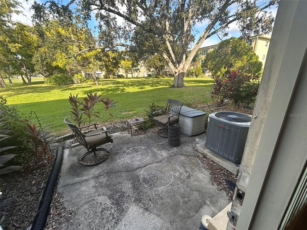 2402 Ecuadorian Way, Unit 18 Clearwater, FL 33763 - Photo 32 of 54 a view of a backyard with plants and a patio