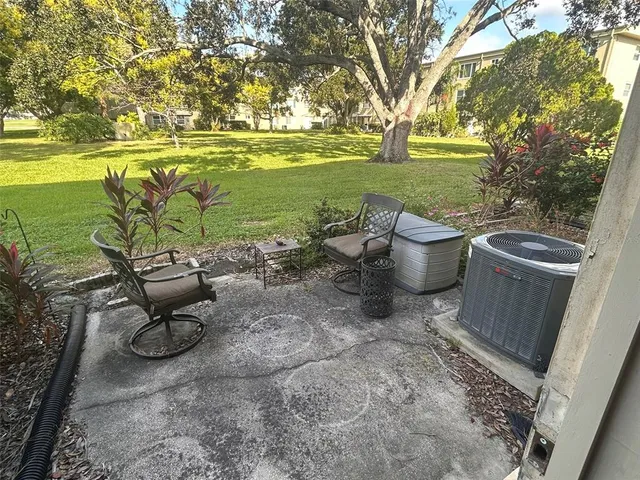 a view of a backyard with plants and a patio