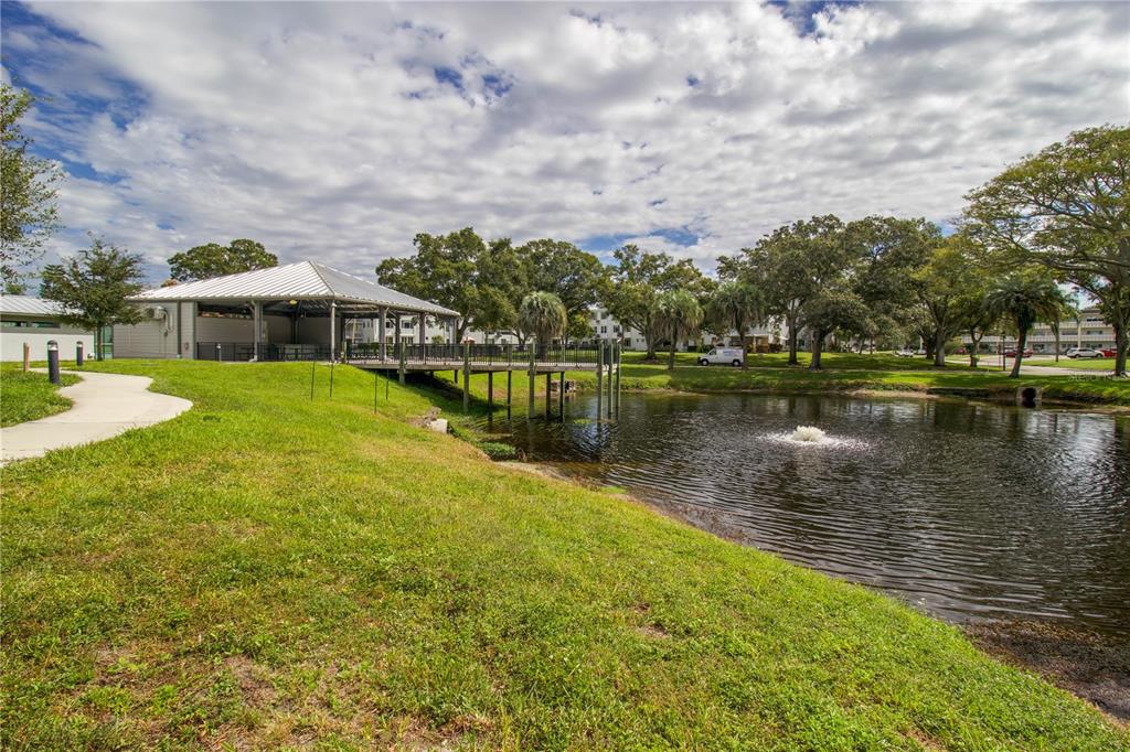 2402 Ecuadorian Way, Unit 18 Clearwater, FL 33763 - Photo 49 of 54 a view of a house with a yard and lake view