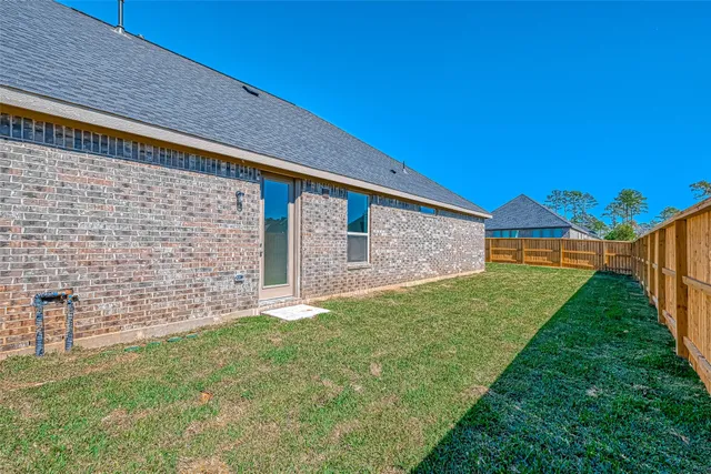 a view of a backyard with wooden fence