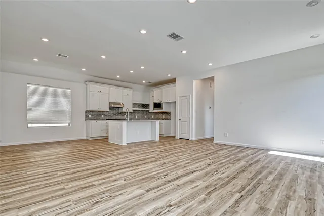 a view of kitchen with granite countertop cabinets and stainless steel appliances