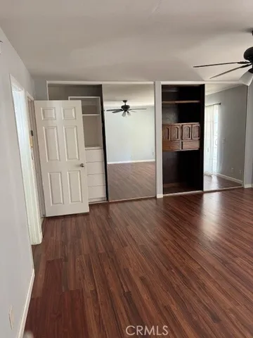 an entryway at an empty room with wooden floor and closet