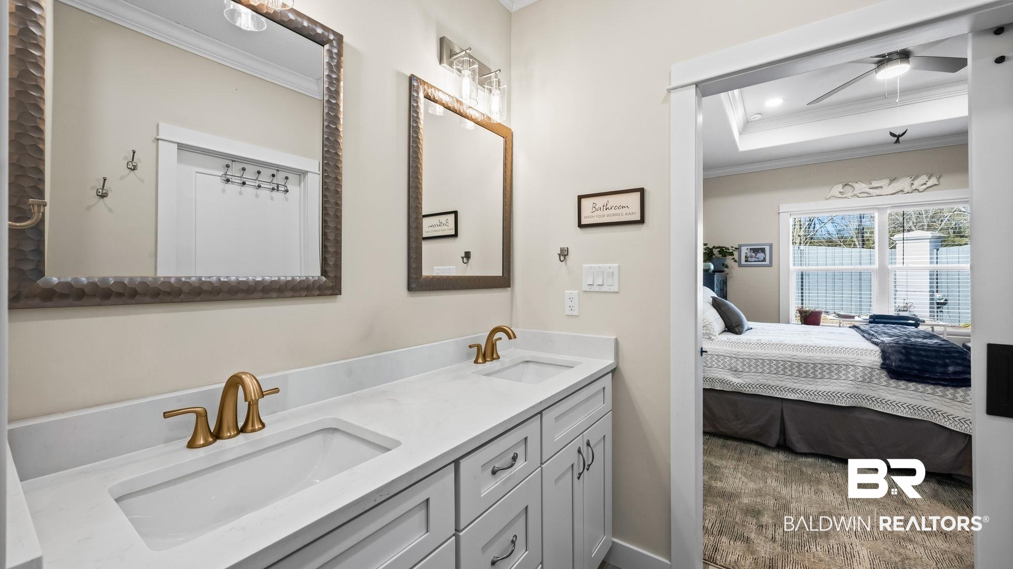 8013 Carmel Circle Foley, AL 36535 - Photo 25 of 49 Ensuite bathroom with crown molding, double vanity, a ceiling fan, and a tray ceiling
