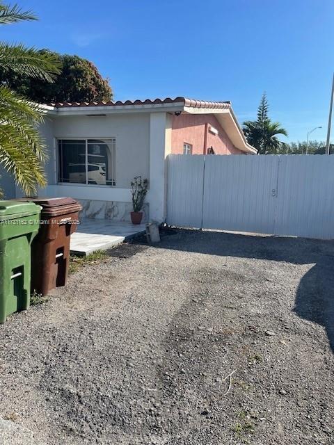 Hialeah Acres Hialeah, FL 33012 - Photo 3 of 9 a backyard of a house with table and chairs