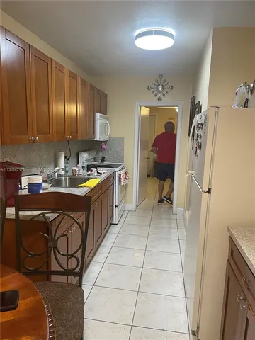 a kitchen with a sink a stove and a refrigerator
