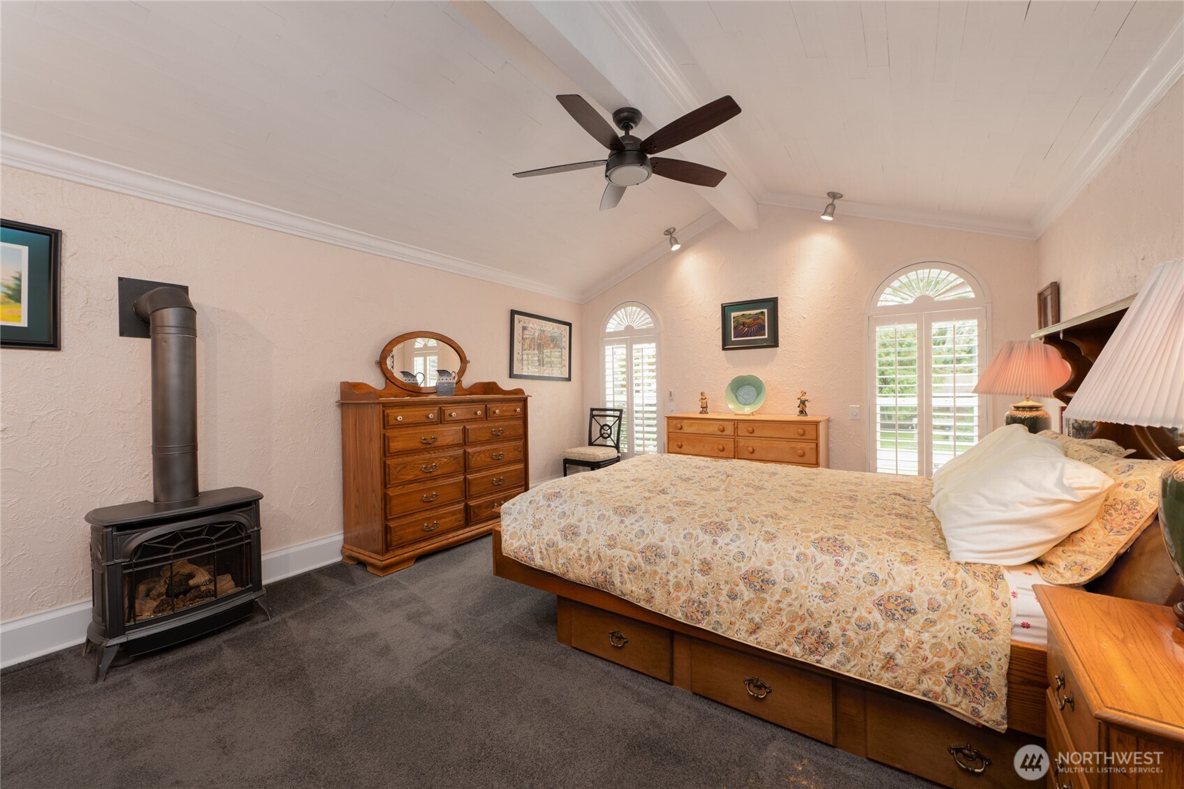 14615 205th Avenue Southeast Renton, WA 98059 - Photo 12 of 40 a bedroom with a bed a dresser and a chandelier