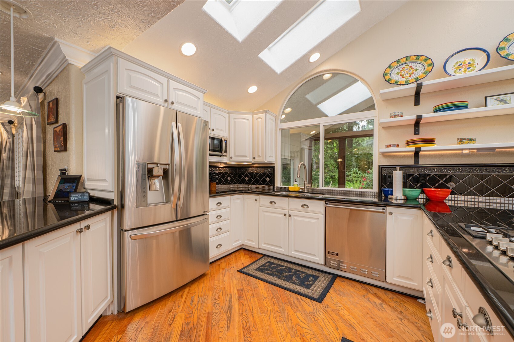14615 205th Avenue Southeast Renton, WA 98059 - Photo 4 of 40 a kitchen with stainless steel appliances a refrigerator sink and stove