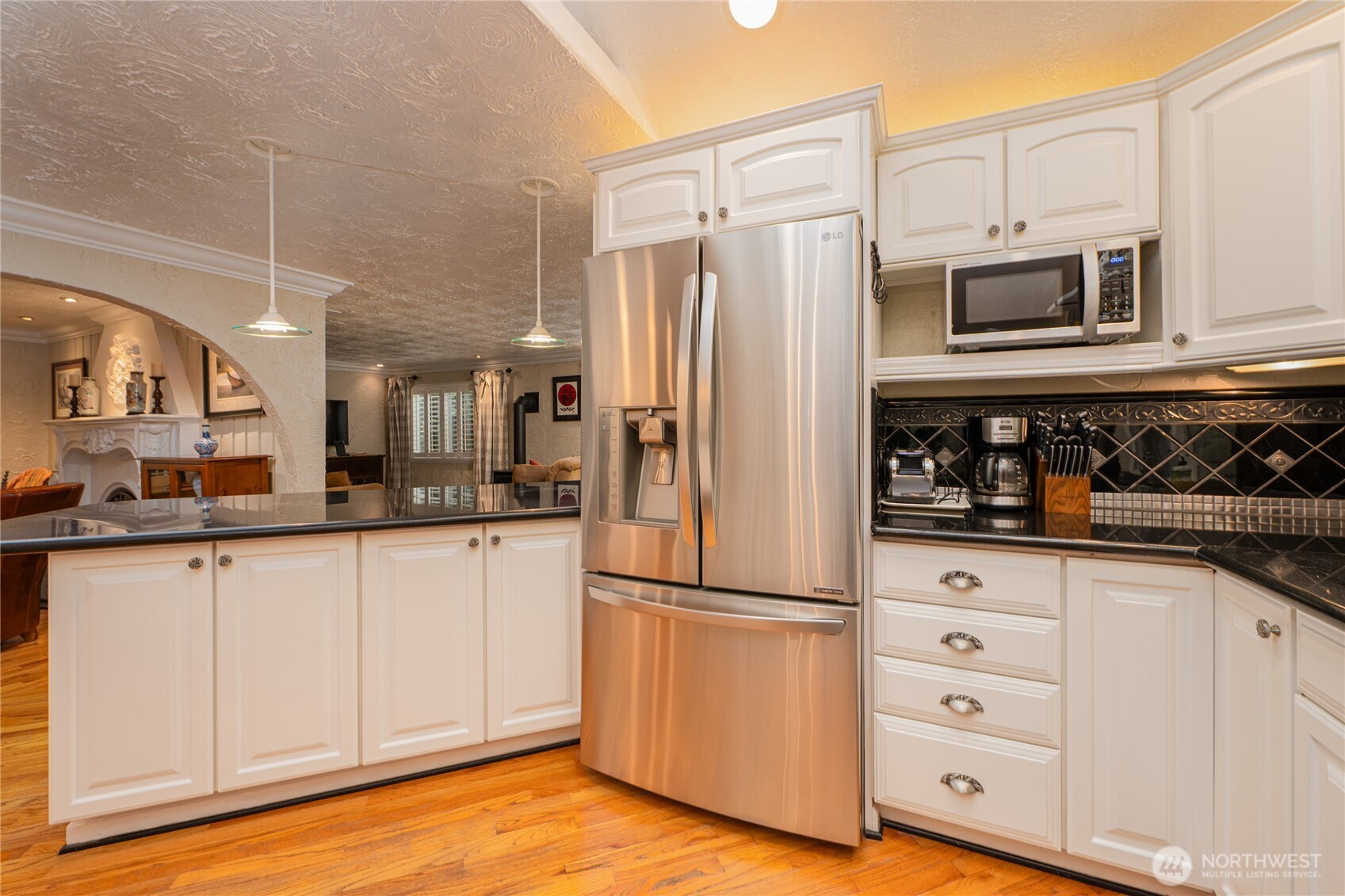 14615 205th Avenue Southeast Renton, WA 98059 - Photo 6 of 40 a kitchen with stainless steel appliances granite countertop a refrigerator sink and cabinets