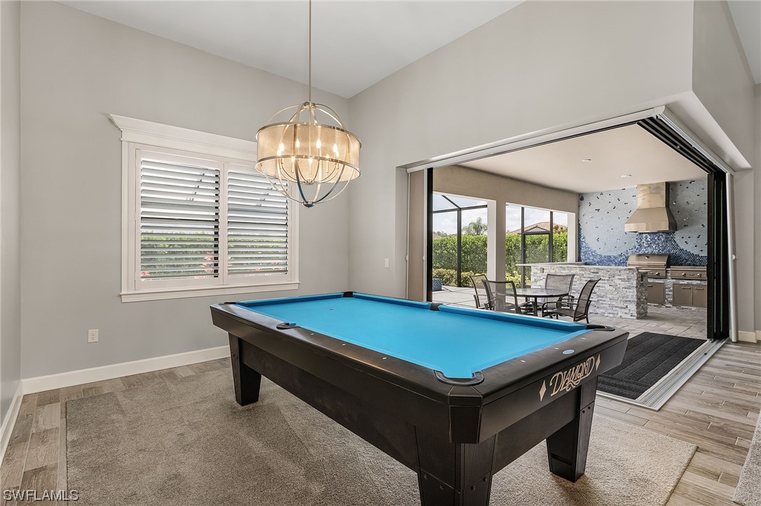 17405 Cabrini Way Estero, FL 33928 - Photo 11 of 34 a room with pool table and windows