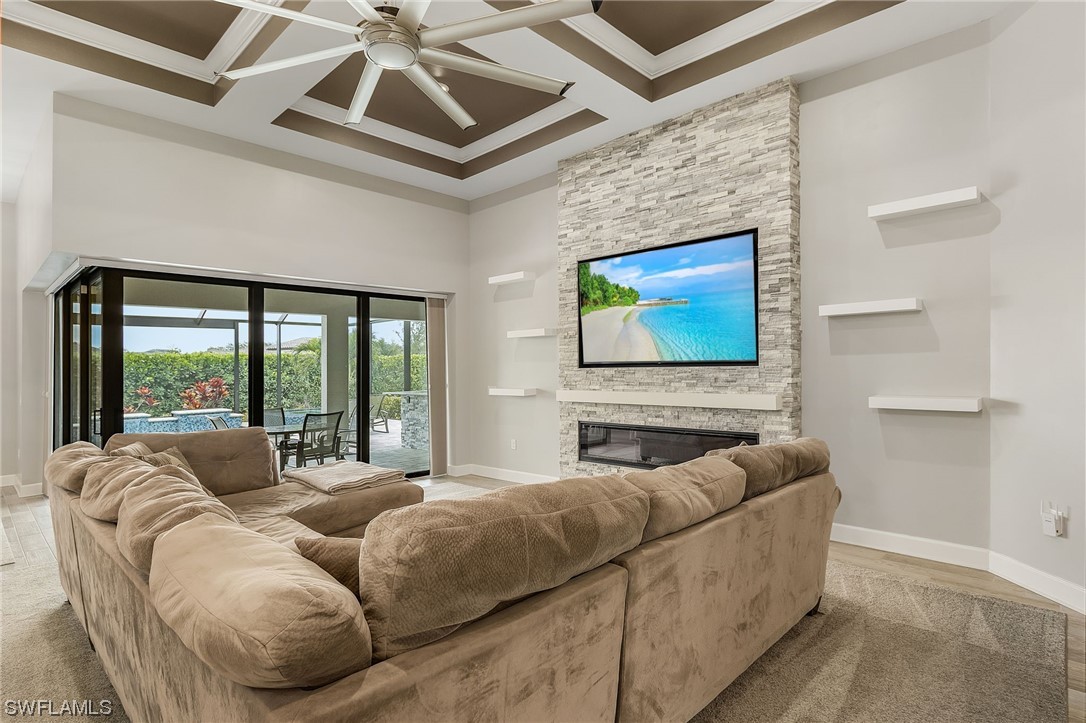 17405 Cabrini Way Estero, FL 33928 - Photo 12 of 34 a living room with furniture a large window and a flat screen tv