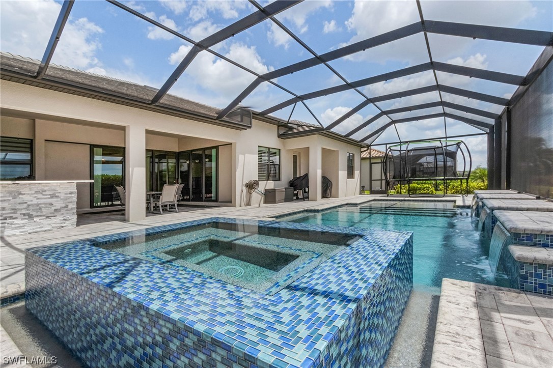17405 Cabrini Way Estero, FL 33928 - Photo 16 of 34 a view of a swimming pool with a patio