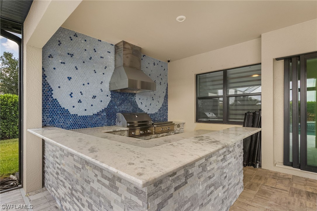 17405 Cabrini Way Estero, FL 33928 - Photo 19 of 34 a view of kitchen island with furniture and window
