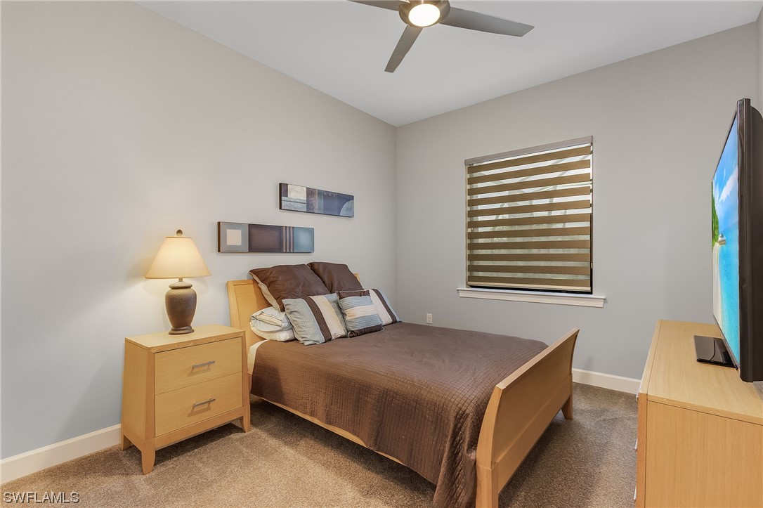 17405 Cabrini Way Estero, FL 33928 - Photo 20 of 34 a bedroom with a bed and a flat screen tv