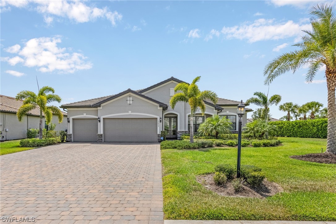 17405 Cabrini Way Estero, FL 33928 - Photo 2 of 34 a front view of a house with garden