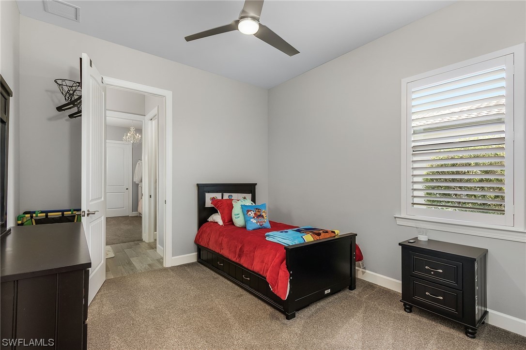 17405 Cabrini Way Estero, FL 33928 - Photo 21 of 34 a bedroom with a bed and a tv
