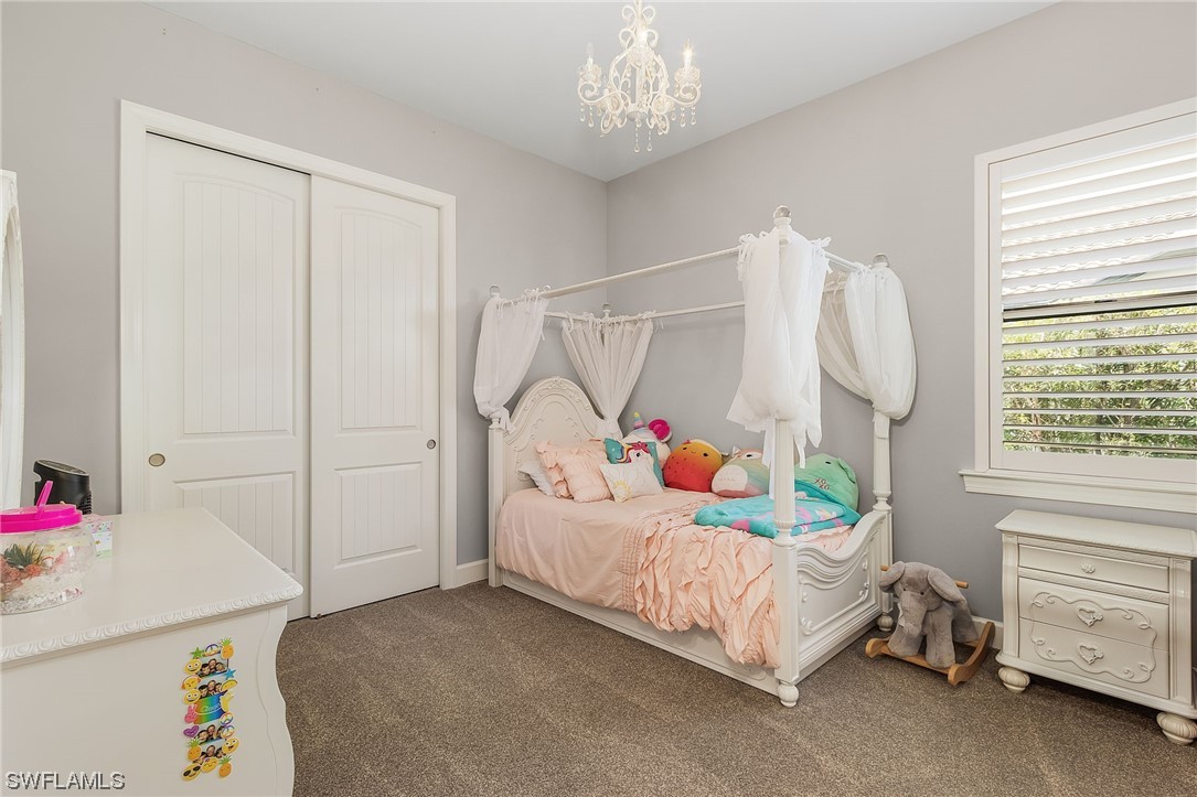 17405 Cabrini Way Estero, FL 33928 - Photo 23 of 34 a bedroom that has a bed and a baby bed
