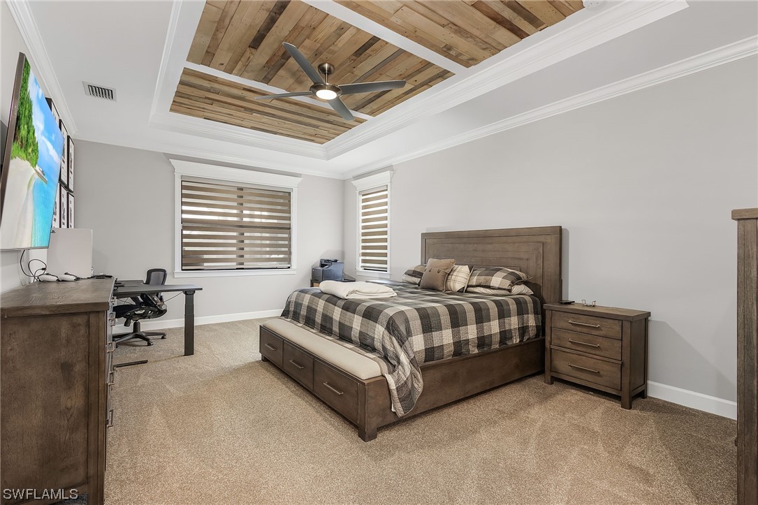 17405 Cabrini Way Estero, FL 33928 - Photo 24 of 34 a spacious bedroom with a bed a couch and a flat tv screen on dresser