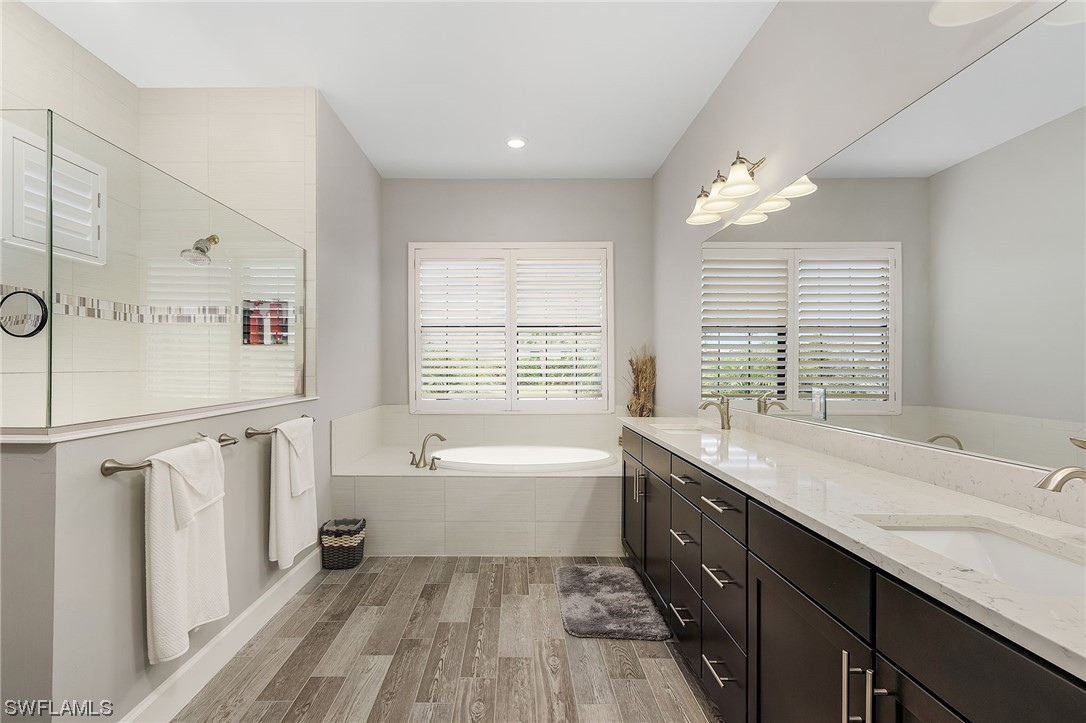17405 Cabrini Way Estero, FL 33928 - Photo 27 of 34 a spacious bathroom with a tub sink and mirror