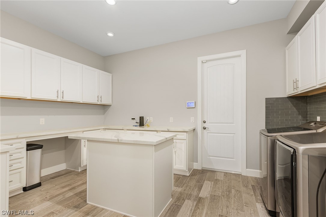 17405 Cabrini Way Estero, FL 33928 - Photo 30 of 34 a kitchen with a sink stove and cabinets