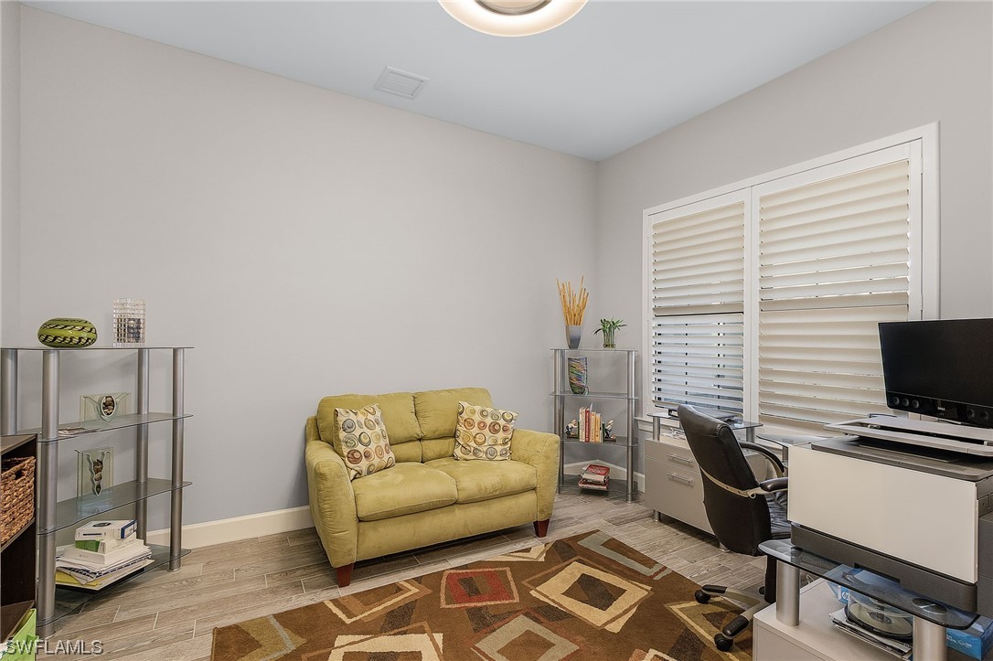 17405 Cabrini Way Estero, FL 33928 - Photo 6 of 34 a living room with furniture and a flat screen tv