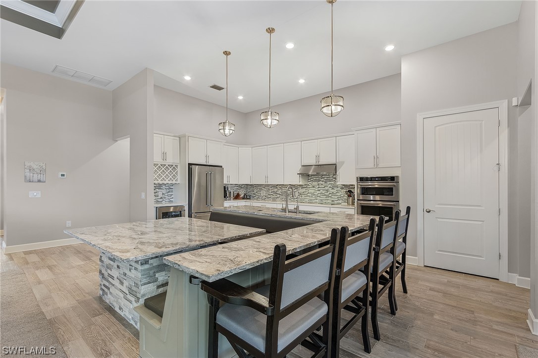17405 Cabrini Way Estero, FL 33928 - Photo 10 of 34 a kitchen with a table and chairs in it