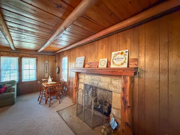 a living room with furniture fireplace and a large window