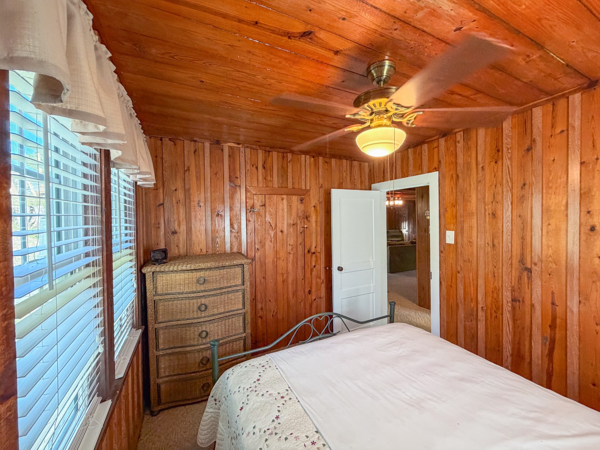 2701 Clear Creek Road Pulaski, TN 38478 - Photo 21 of 42 a bedroom with a bed and a chandelier