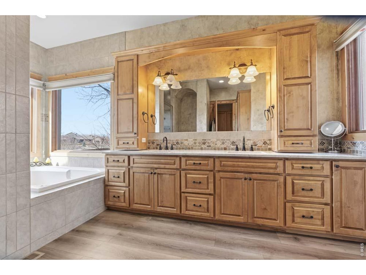 964 Riparian Way Fort Collins, CO 80524 - Photo 32 of 42 a spacious bathroom with a granite countertop sink mirror and a