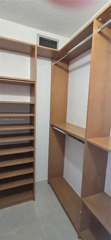 a bathroom with a granite countertop shower and a sink