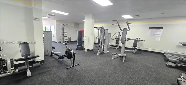 a room with stainless steel appliances kitchen island granite countertop lots of clutter