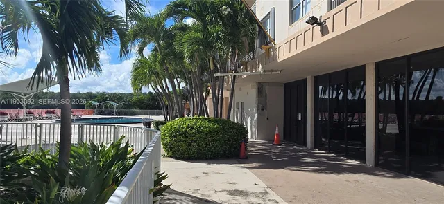 a view of balcony with chairs and wooden fence