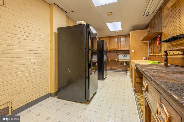 a view of a kitchen with a sink and cabinets