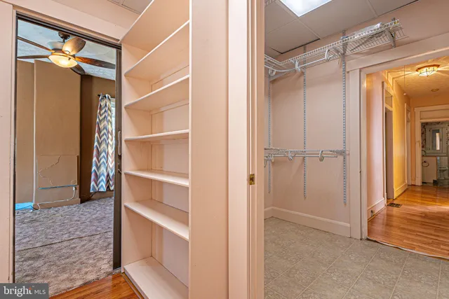 a view of walk in closet with empty racks