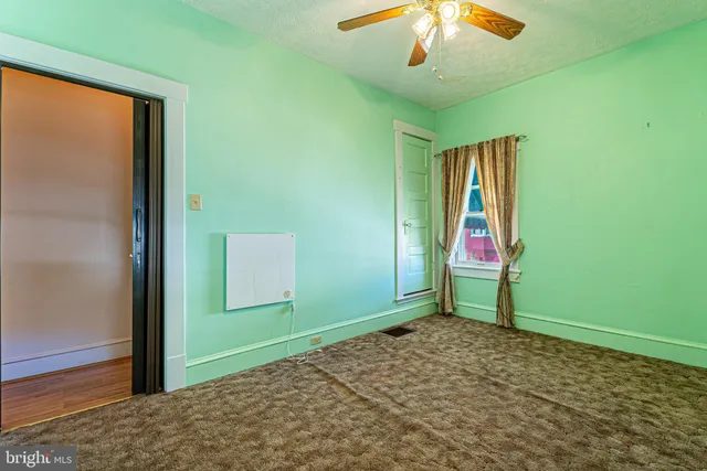an entryway with a table and a chandelier