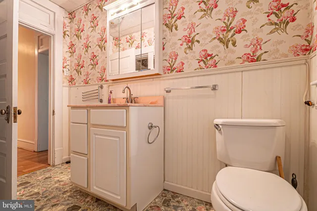 a white toilet sitting next to a bathroom sink