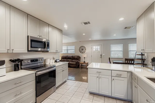 a kitchen with a sink cabinets and stainless steel appliances