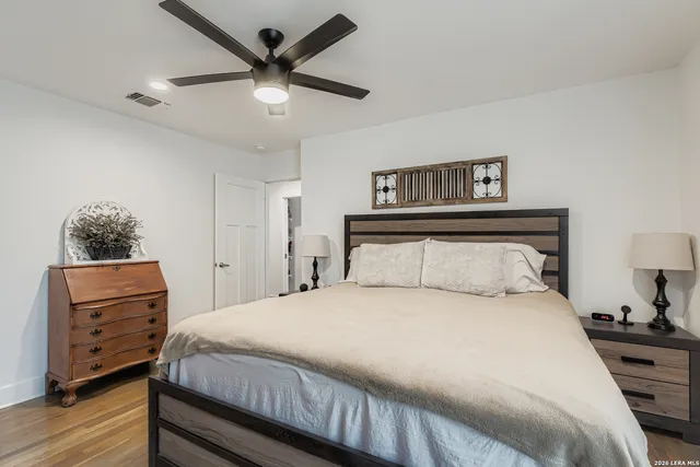 a bedroom with a bed and wooden floor