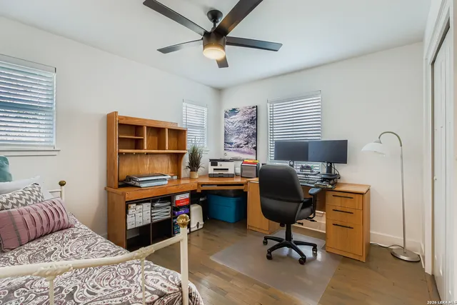 a view of a livingroom with workspace and a window