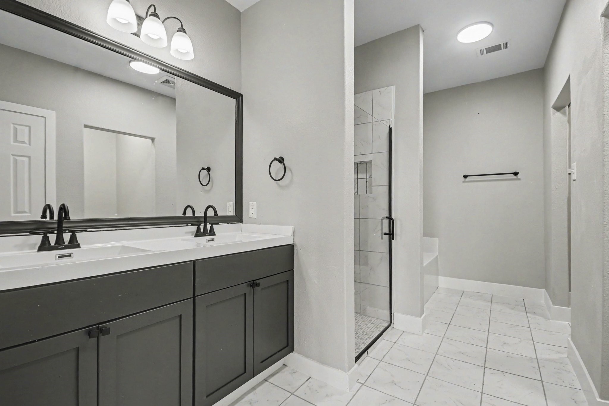 1322 Diamond Drape Drive Rosharon, TX 77583 - Photo 20 of 45 a bathroom with a double vanity sink a mirror and a shower