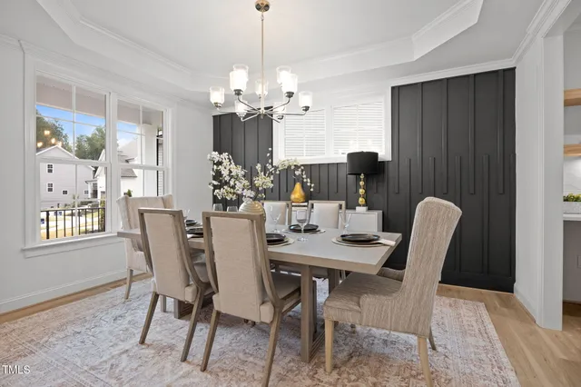 a view of a dining room with furniture and chandelier