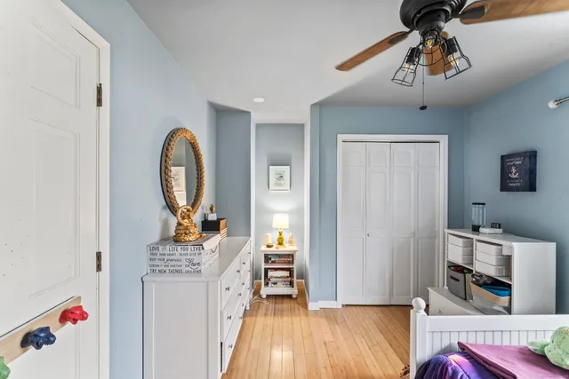 a bed room with furniture and wooden floor