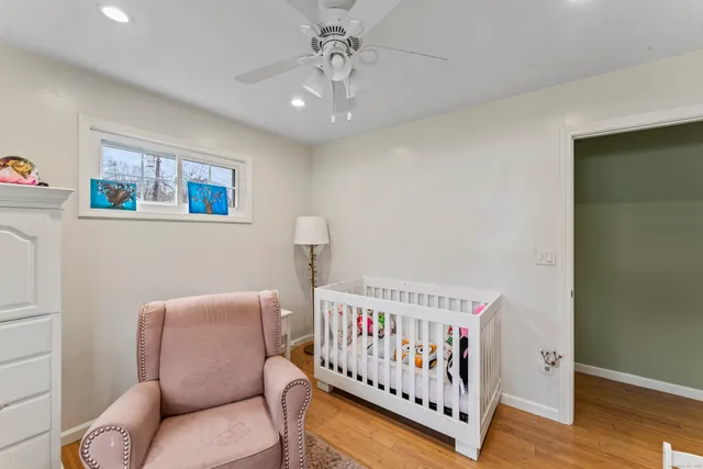 a living room with furniture a bookshelf and a window