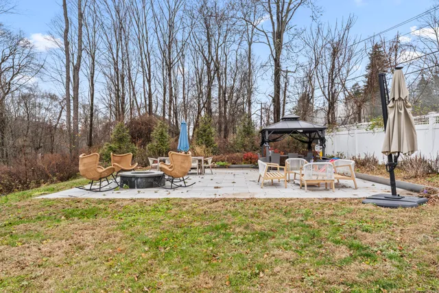 a view of a swimming pool with a bench and trees