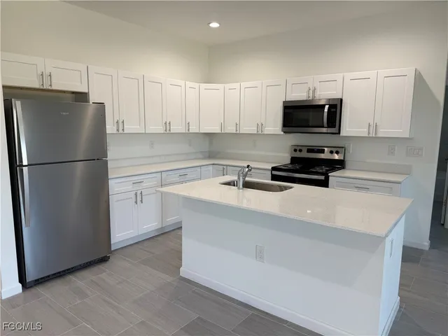 a white refrigerator freezer sitting in a kitchen
