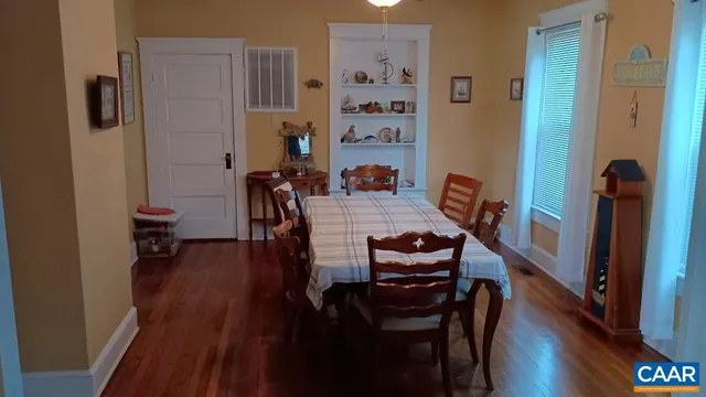 a dining room with furniture and wooden floor