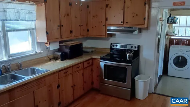a kitchen with stainless steel appliances a stove a microwave and cabinets